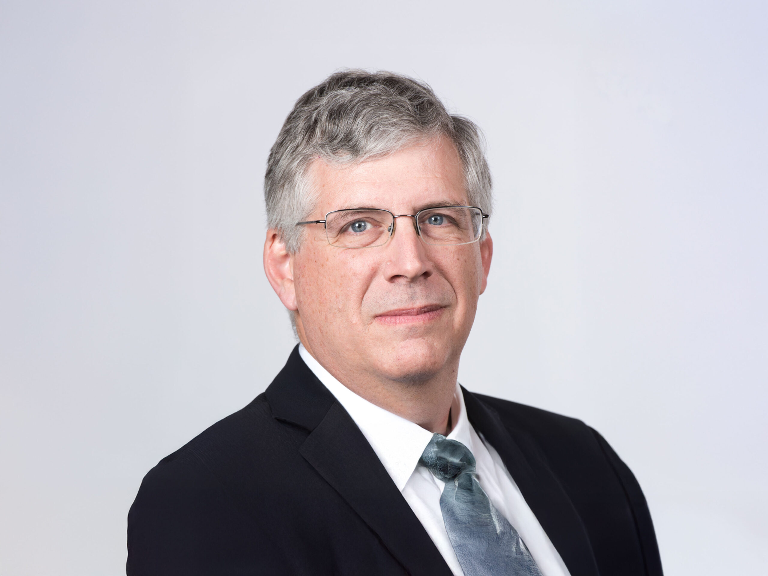Bob Block standing against a light gray background