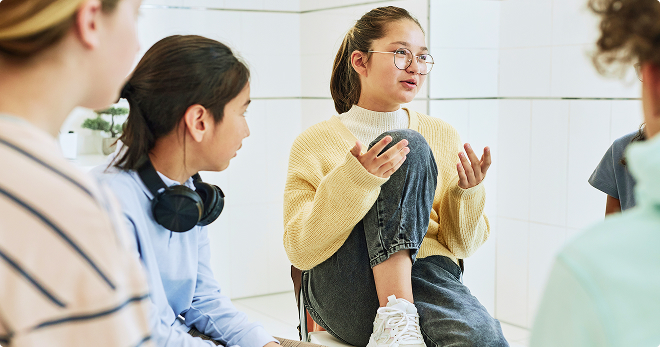 Teenagers sitting in a circle during a group counseling discussion.