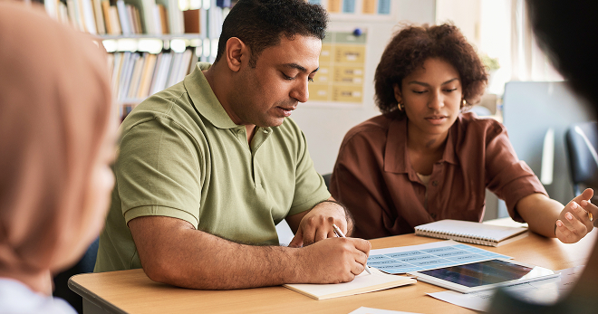 Career counselor instructing a group of job seekers.