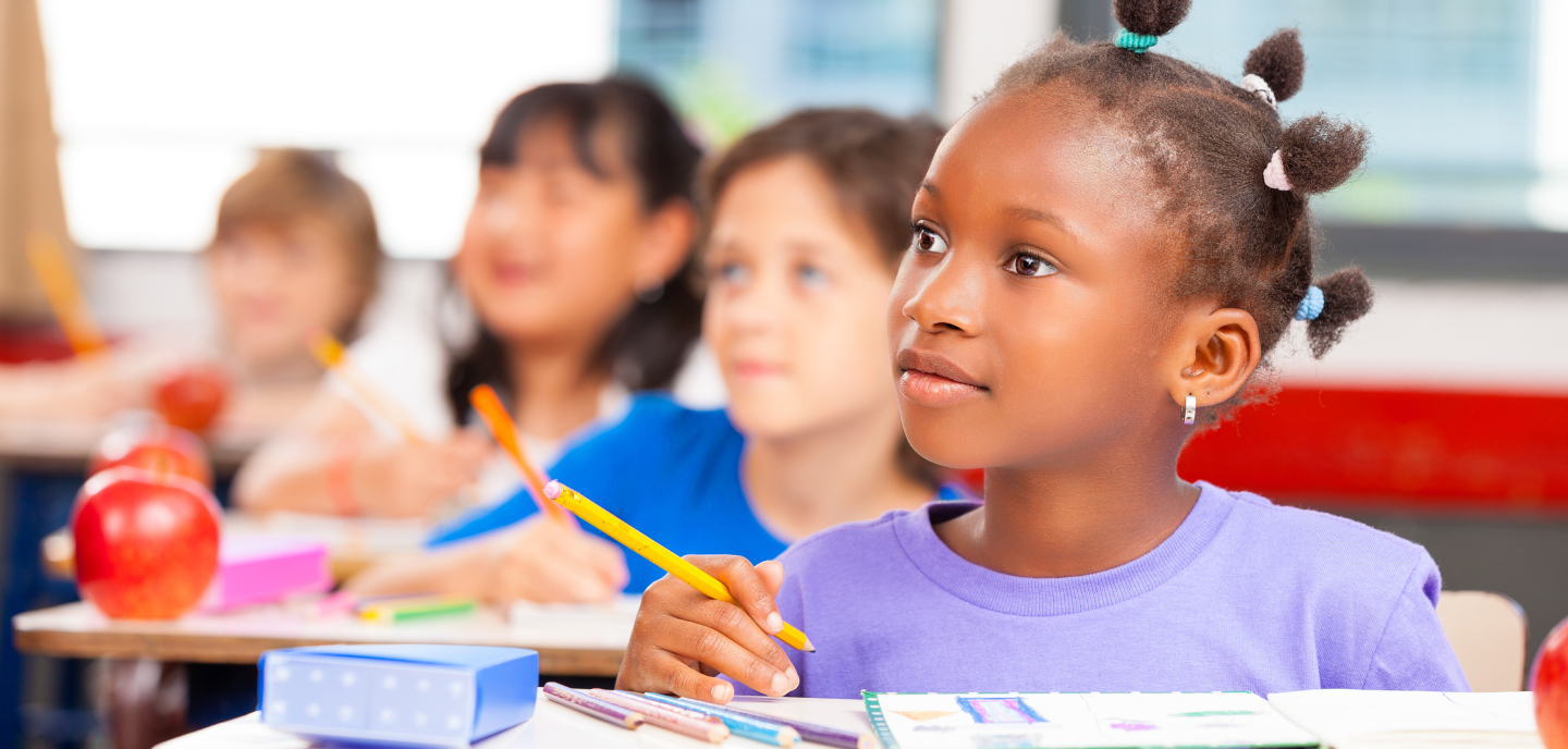 Students sitting at their desks in a classroom.
