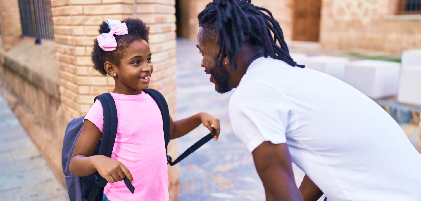 Father greeting his daughter after school.