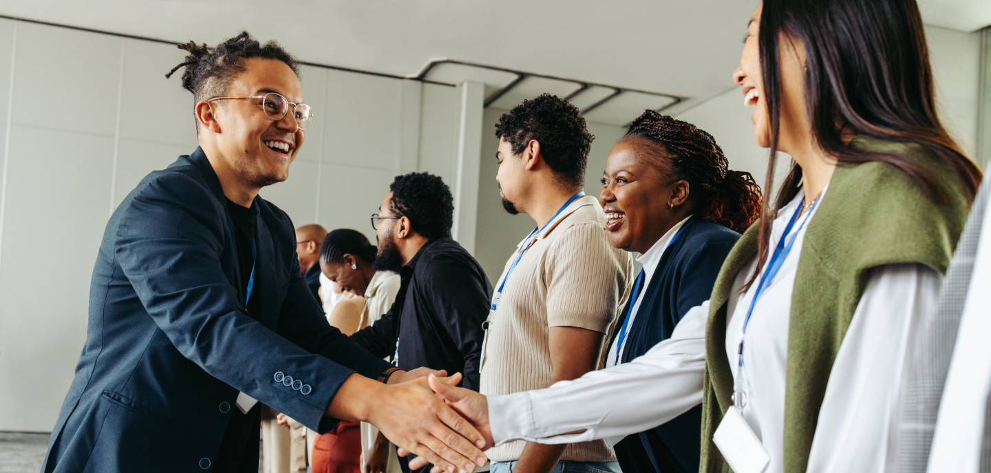 Professionals greeting one another at a conference.