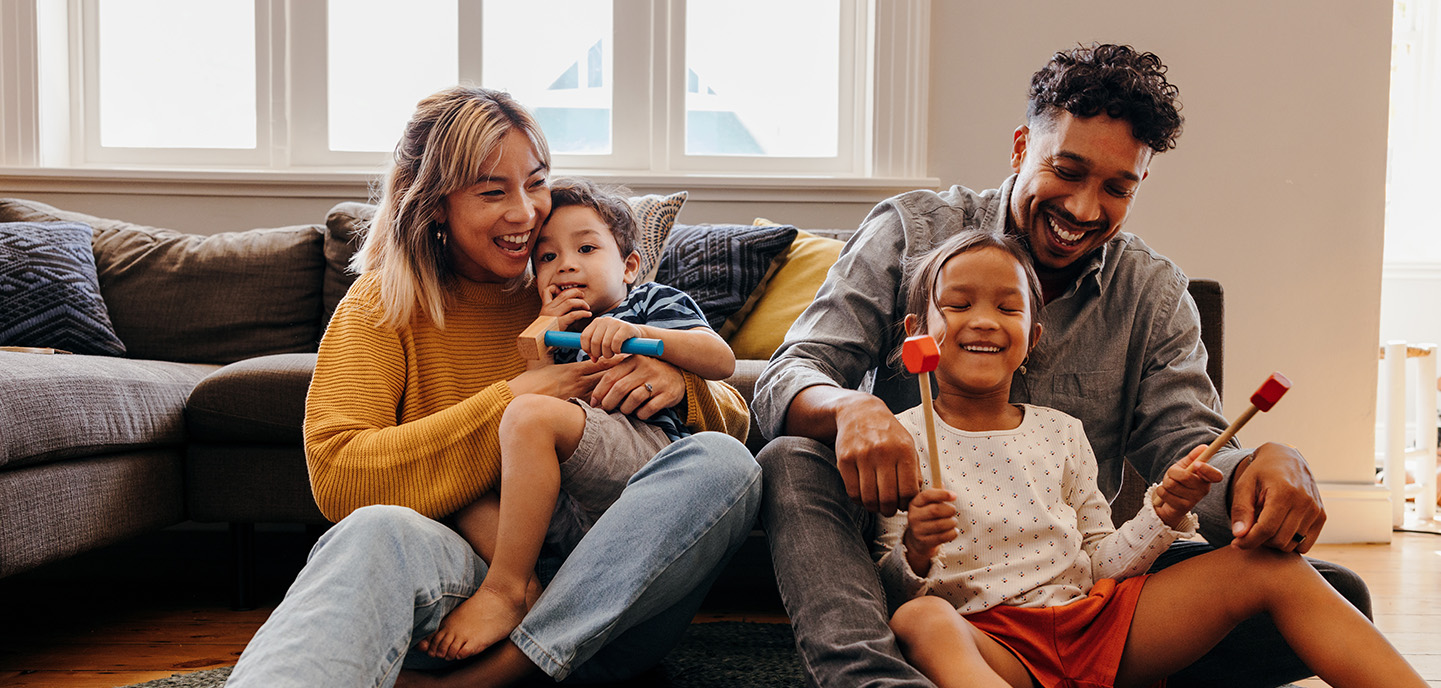 Family sitting on the floor and playing together.