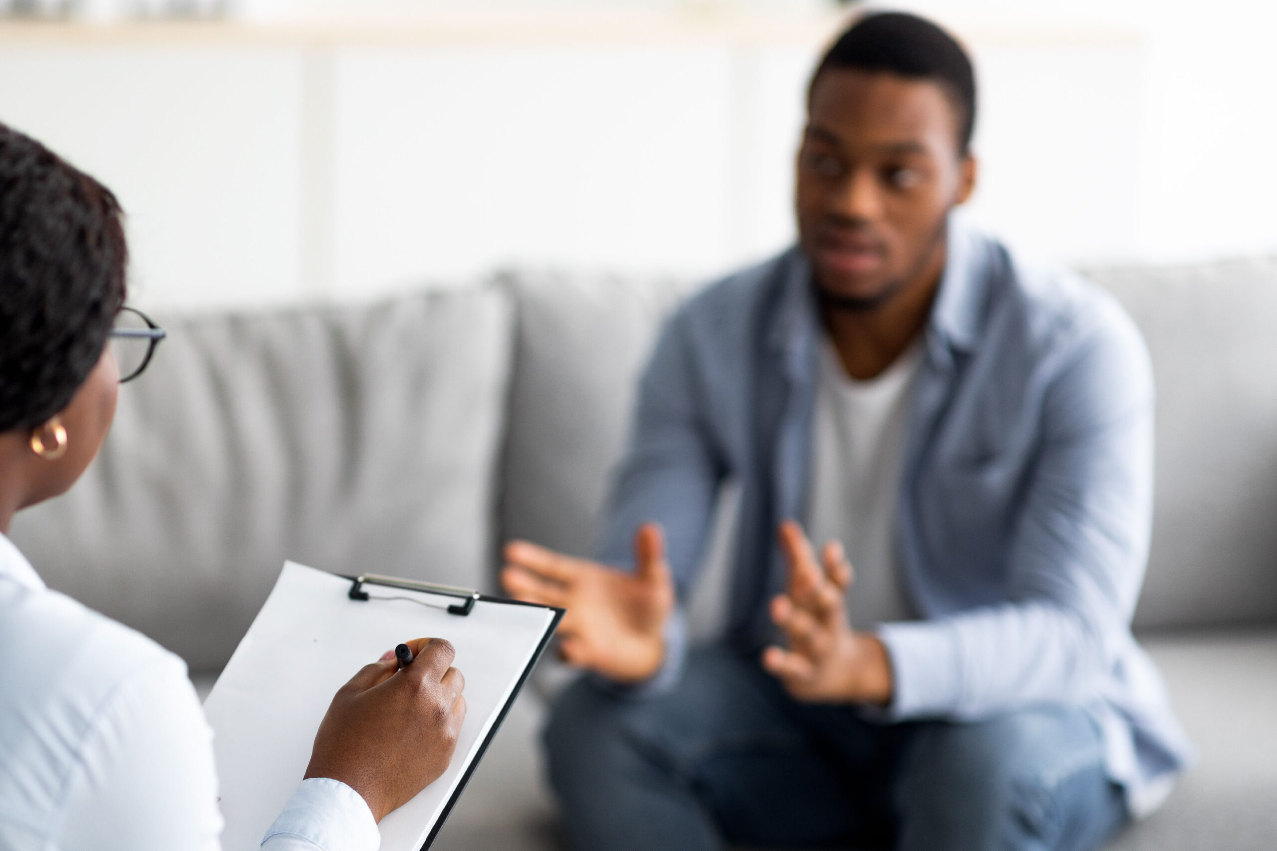 Young man talking with a substance use treatment counselor.