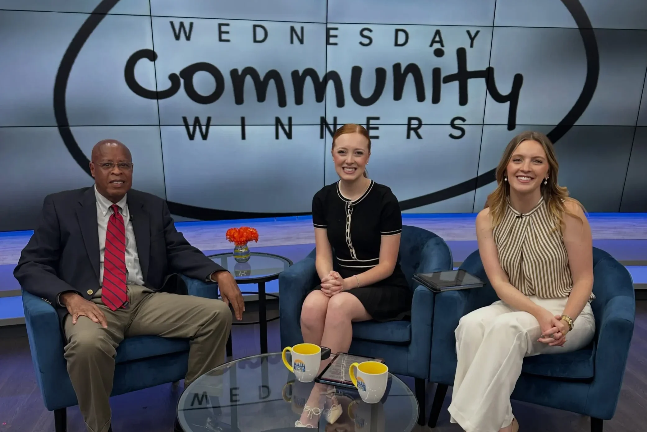Larry Woody sitting on the set of Positively Philly with Abby Urban and Rachel Malak.